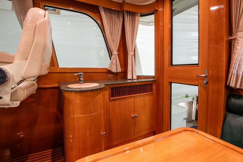 Blue Tang Yacht Photos Pics Interior of 2007 Grand Banks 39 Eastbay SX with wood finish and compact sink area.