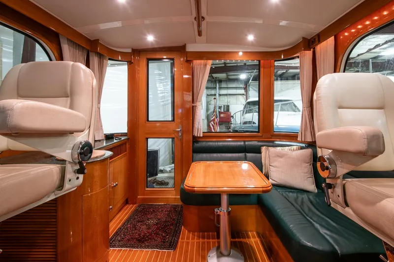 Blue Tang Yacht Photos Pics Luxurious interior of 2007 Grand Banks 39 Eastbay SX yacht with plush seating and wooden finishes.