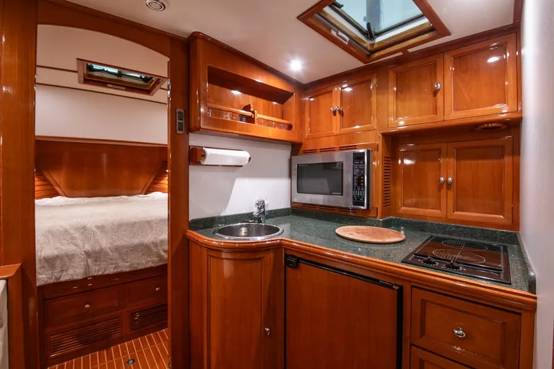 Blue Tang Yacht Photos Pics Luxurious 2007 Grand Banks 39 Eastbay SX yacht interior with wood cabinetry and modern kitchen amenities.