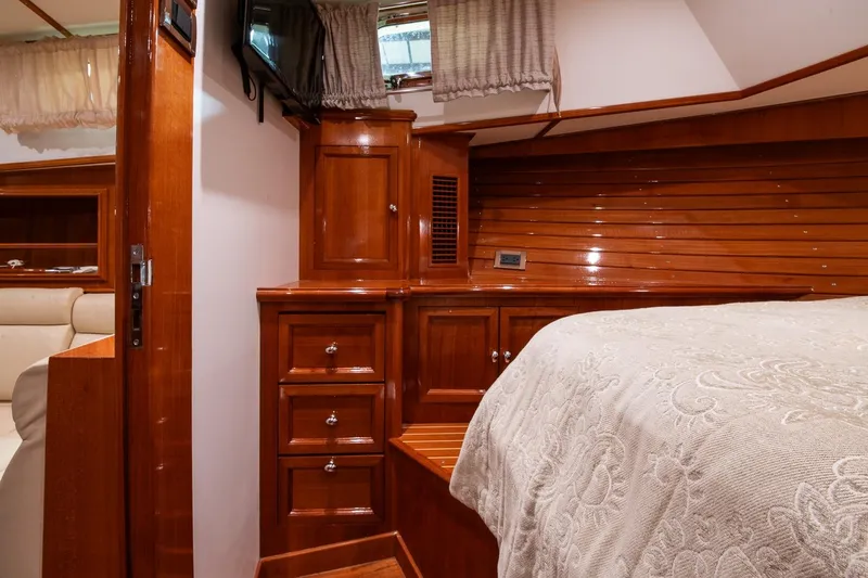 Blue Tang Yacht Photos Pics Luxurious 2007 Grand Banks 39 Eastbay SX cabin with elegant wood finish and cozy bedding.