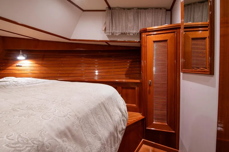 Blue Tang Yacht Photos Pics Luxurious 2007 Grand Banks 39 Eastbay SX cabin with elegant wood paneling and cozy bedding.