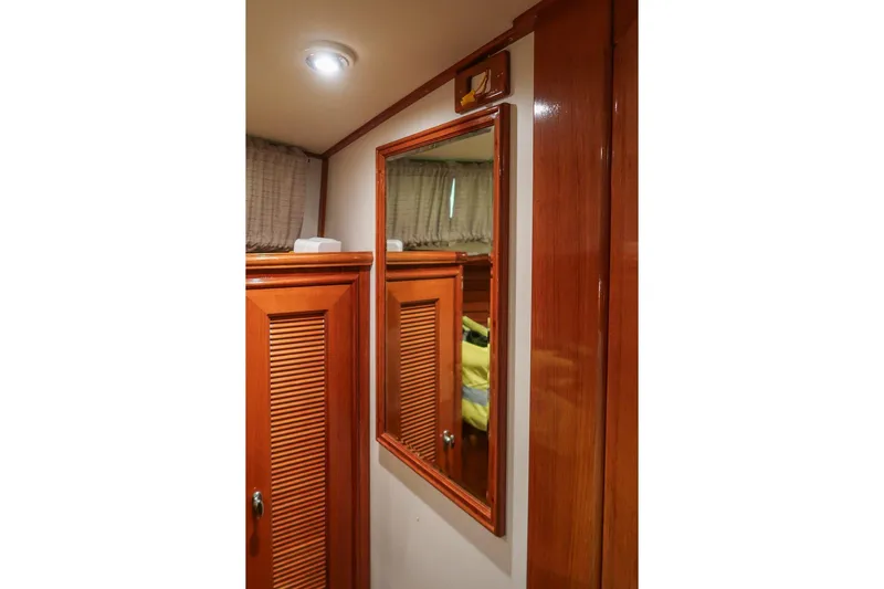 Blue Tang Yacht Photos Pics Interior of 2007 Grand Banks 39 Eastbay SX with wooden cabinetry and mirror.
