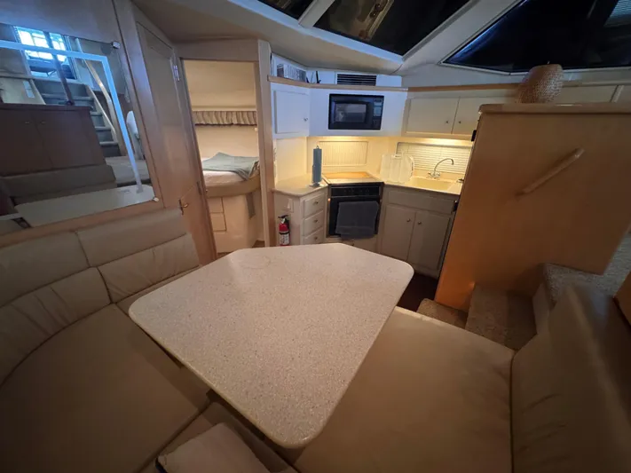  Yacht Photos Pics Interior of 1998 Carver 405 Aft Cabin yacht with kitchen and dining area.