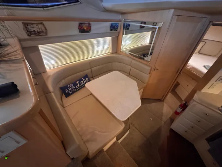  Yacht Photos Pics 1998 Carver 405 Aft Cabin interior with cozy dining area and decorative pillow.