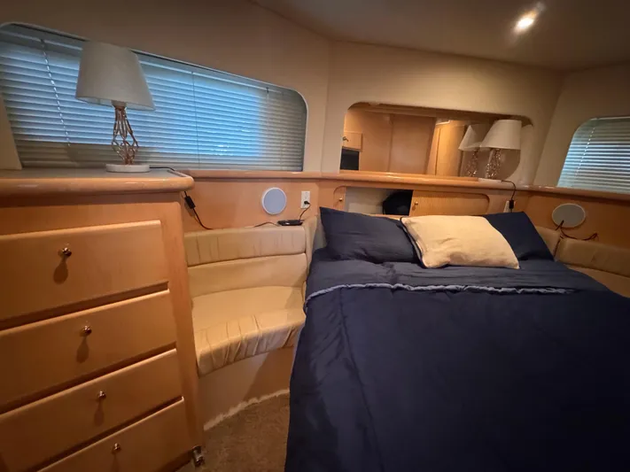  Yacht Photos Pics Luxurious 1998 Carver 405 Aft Cabin bedroom with cozy bed and elegant decor.