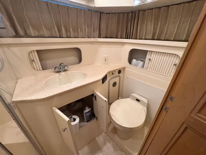  Yacht Photos Pics 1998 Carver 405 Aft Cabin bathroom with sink, toilet, and storage cabinets.