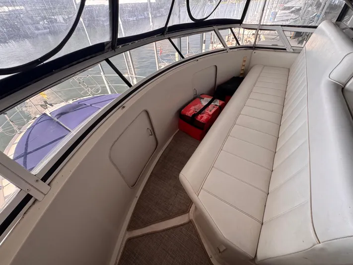  Yacht Photos Pics 1998 Carver 405 Aft Cabin interior with white seating and marina view.