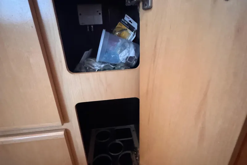  Yacht Photos Pics Open cabinet on 1998 Carver 405 Aft Cabin boat, showing storage compartments and miscellaneous items.