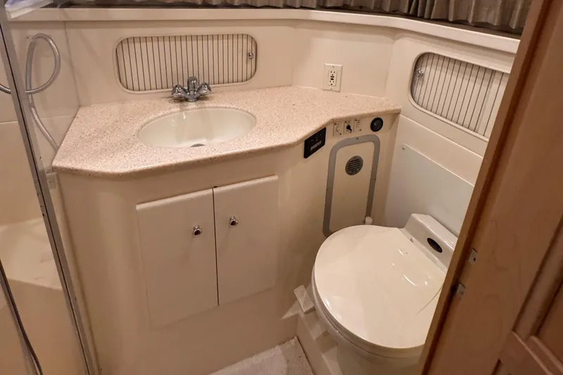  Yacht Photos Pics 1998 Carver 405 Aft Cabin bathroom with sink, toilet, and shower.