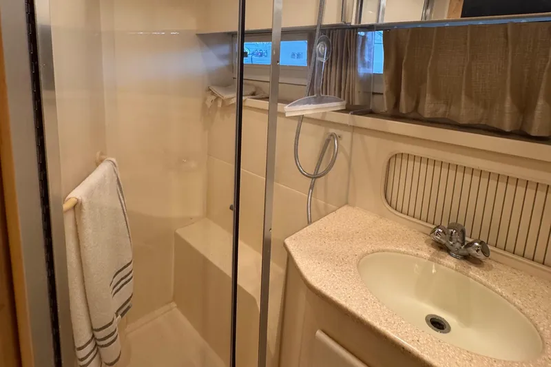  Yacht Photos Pics 1998 Carver 405 Aft Cabin bathroom with shower, sink, and towel rack.