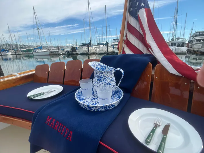 Maruffa Yacht Photos Pics 1980 Dyer 29 boat with American flag, marina view, and elegant table setting.