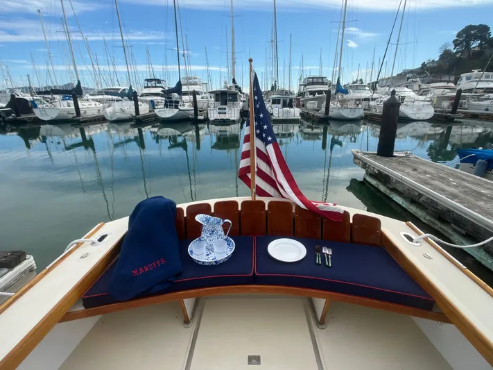 Maruffa Yacht Photos Pics Dyer 29 boat interior with American flag, marina view, and table setting, 1980 model.