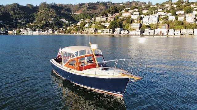 Maruffa Yacht Photos Pics 1980 Dyer 29 boat on calm water with scenic hillside background.