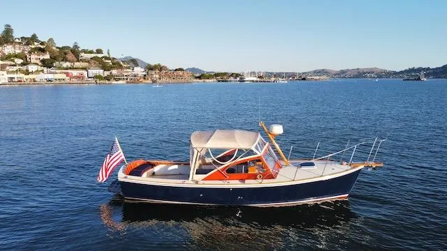 Maruffa Yacht Photos Pics 1980 Dyer 29 boat on calm water with American flag, scenic coastal background.
