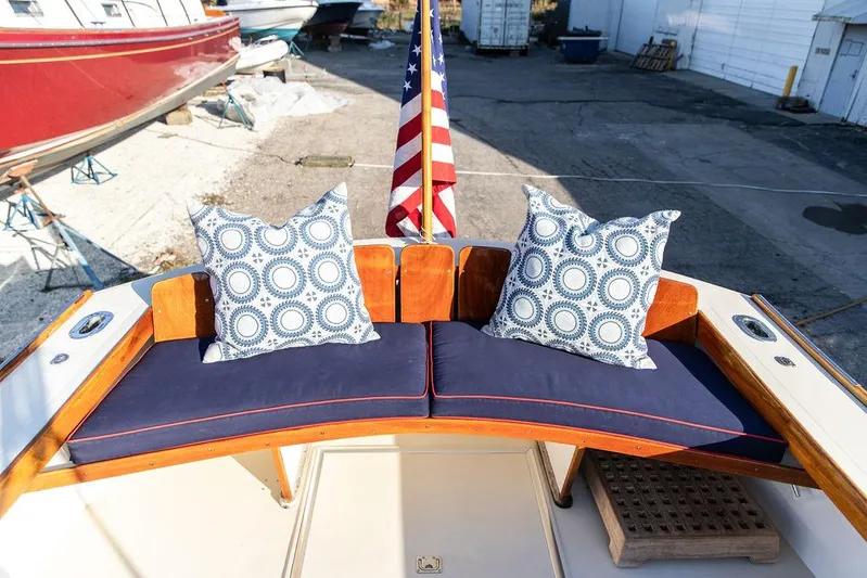 Maruffa Yacht Photos Pics 1980 Dyer 29 boat with blue cushions, patterned pillows, and American flag in a marina setting.