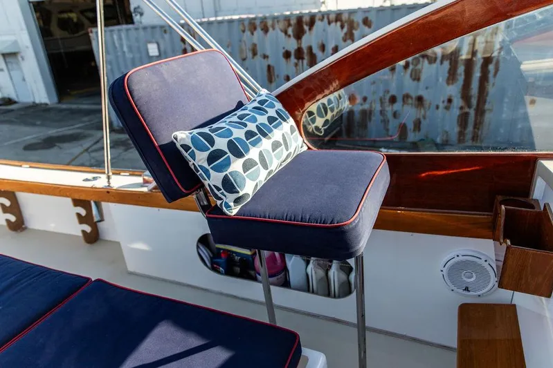 Maruffa Yacht Photos Pics 1980 Dyer 29 boat interior with blue cushioned seating and decorative pillow.