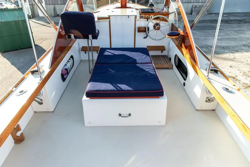 Maruffa Yacht Photos Pics 1980 Dyer 29 boat interior with blue cushions and wooden accents.