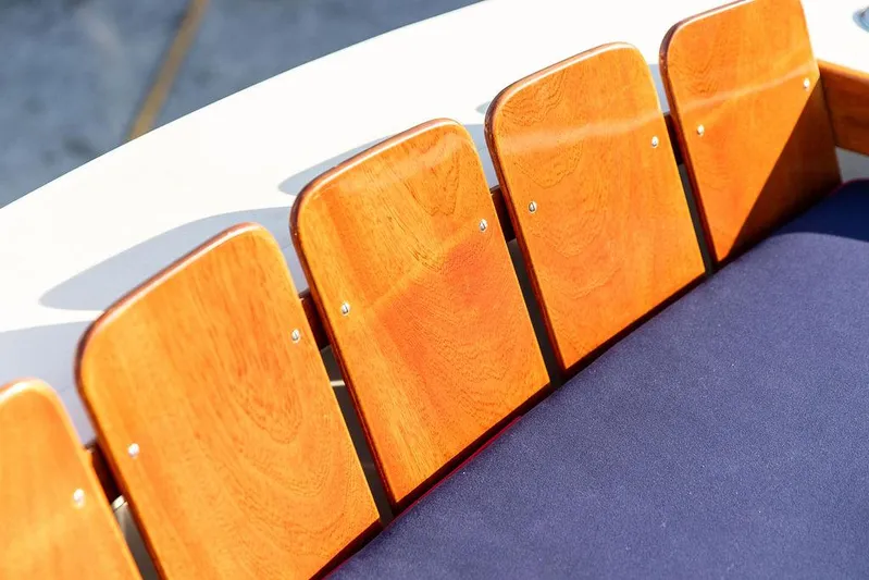 Maruffa Yacht Photos Pics Wooden boat seating on a 1980 Dyer 29, featuring polished panels and blue upholstery.