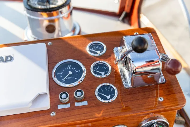 Maruffa Yacht Photos Pics 1980 Dyer 29 boat dashboard with gauges and controls, featuring wood paneling and chrome accents.