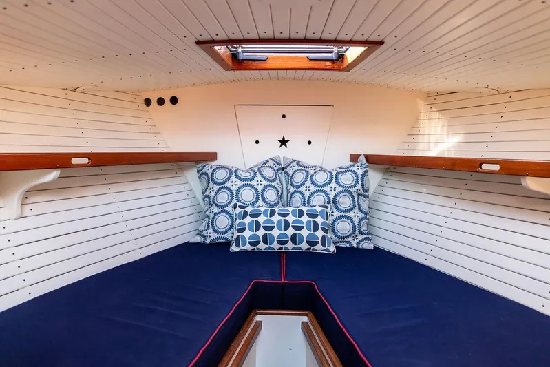 Maruffa Yacht Photos Pics Cozy cabin interior of 1980 Dyer 29 boat with patterned cushions and wooden accents.