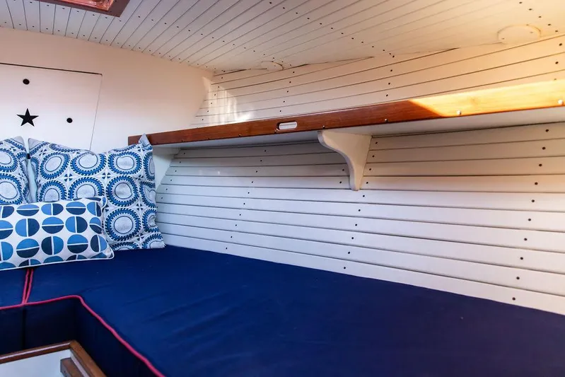 Maruffa Yacht Photos Pics 1980 Dyer 29 boat interior with blue cushions and patterned pillows.