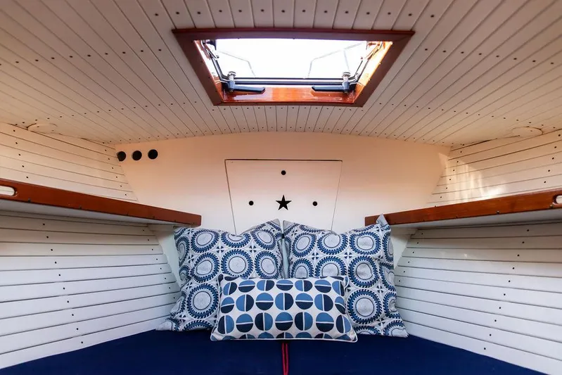 Maruffa Yacht Photos Pics Cozy cabin interior of 1980 Dyer 29 boat with patterned cushions and skylight.