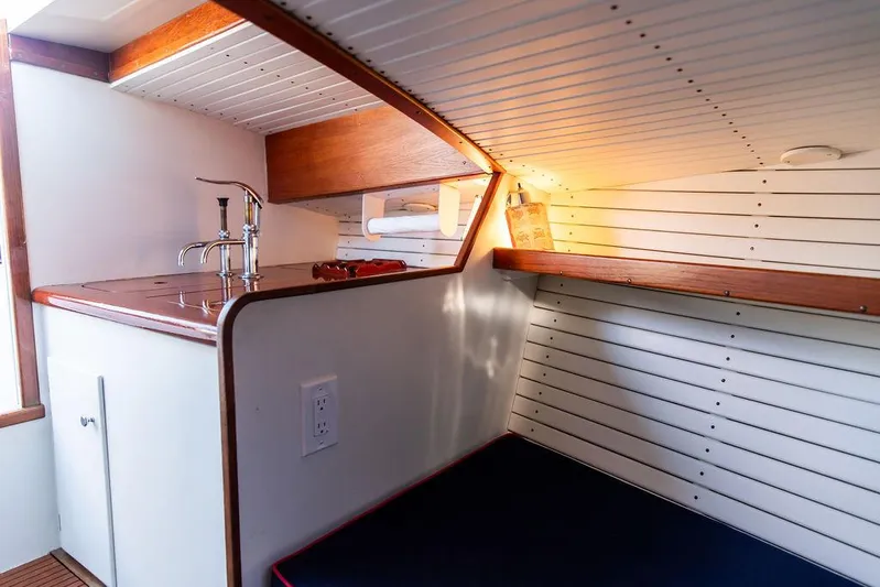 Maruffa Yacht Photos Pics Interior of 1980 Dyer 29 boat with compact kitchen and cozy sleeping area.