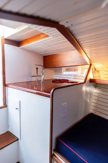 Maruffa Yacht Photos Pics 1980 Dyer 29 boat interior with wooden accents and compact kitchen area.