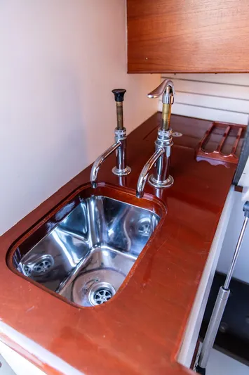Maruffa Yacht Photos Pics Stainless steel sink on a 1980 Dyer 29 boat with wooden countertop.