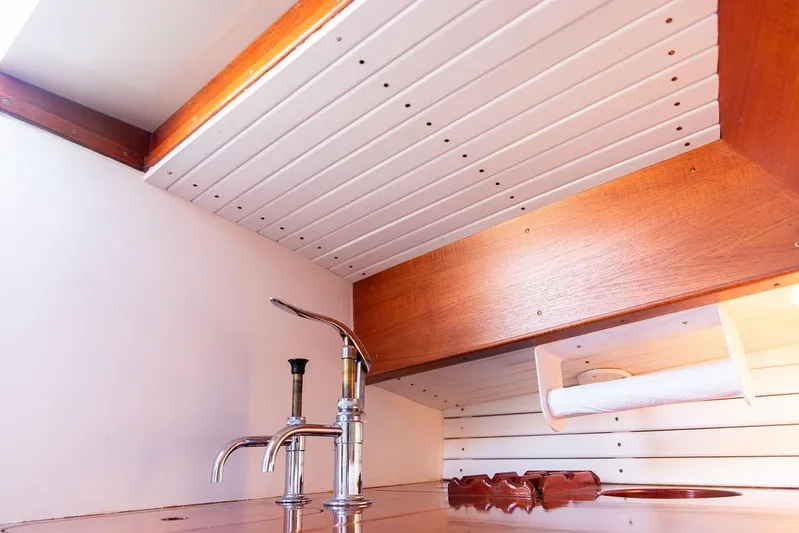 Maruffa Yacht Photos Pics Interior of 1980 Dyer 29 boat with wooden cabinetry and modern faucet.