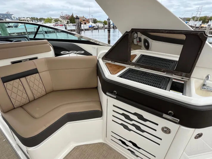 Knot On Call Yacht Photos Pics 2018 Sea Ray 310 SLX boat interior with seating and grill, docked at marina.