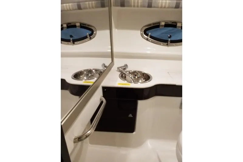  Yacht Photos Pics 2019 Formula 310 Sun Sport boat interior with sink and porthole window.