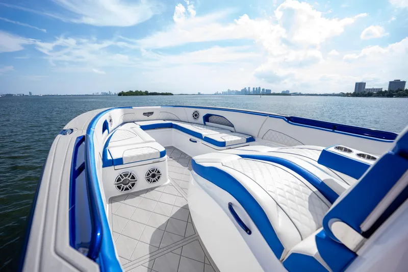  Yacht Photos Pics 2024 Deep Impact 399 Sport boat with luxurious seating on a sunny day.