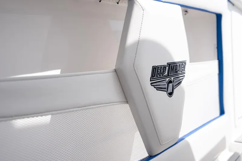  Yacht Photos Pics 2024 Deep Impact 399 Sport boat interior with logo on white upholstery.