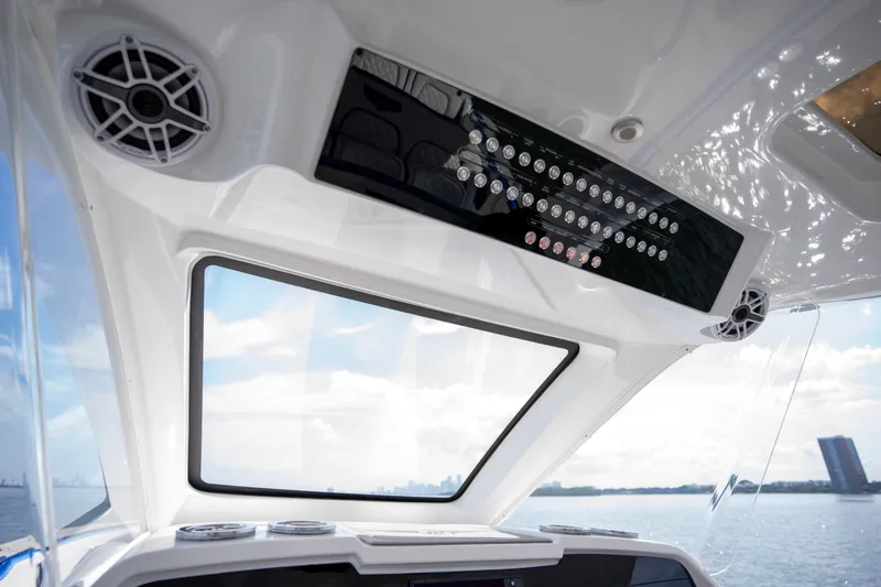 Yacht Photos Pics Interior view of 2024 Deep Impact 399 Sport boat with control panel and speakers.