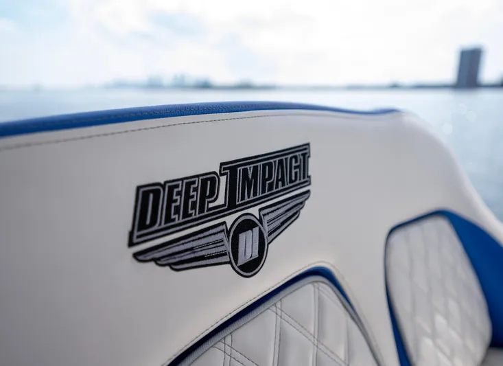  Yacht Photos Pics 2024 Deep Impact 399 Sport boat seat with logo, featuring blue and white design.