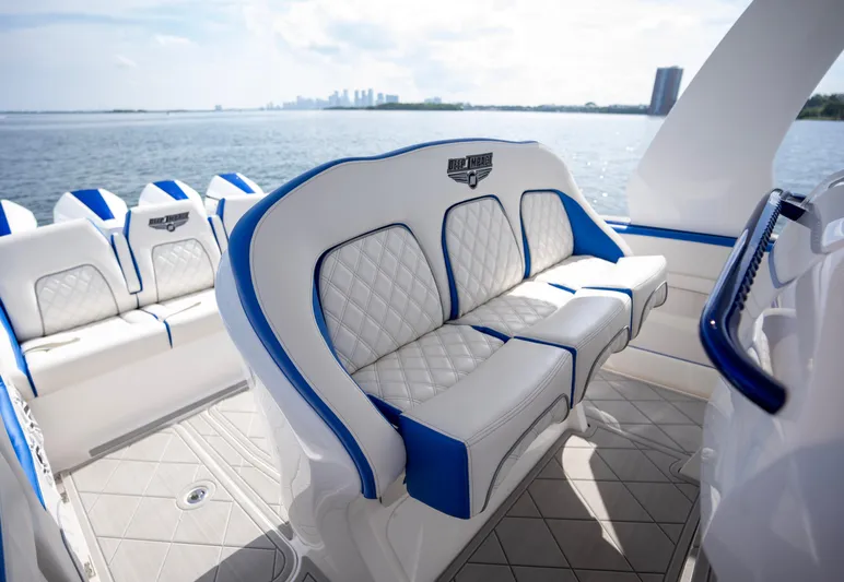  Yacht Photos Pics 2024 Deep Impact 399 Sport boat interior with white and blue seating, ocean view.