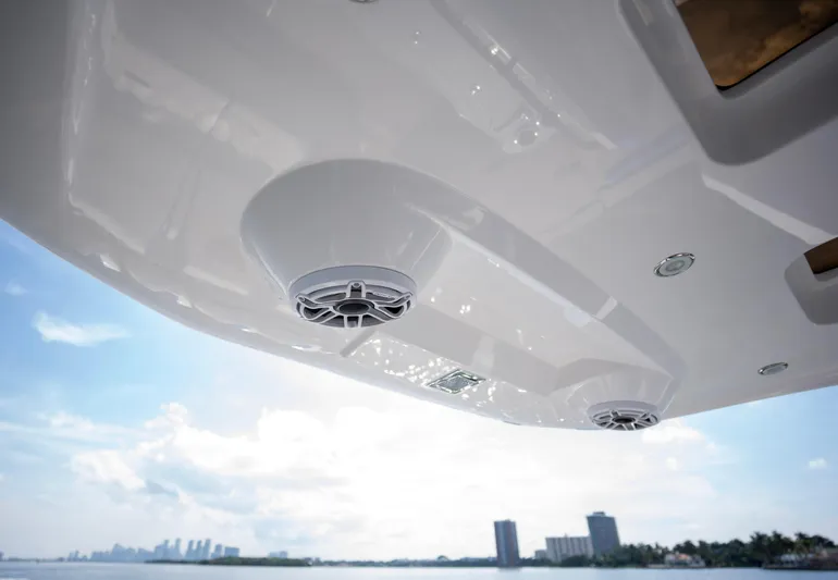  Yacht Photos Pics 2024 Deep Impact 399 Sport boat speakers with city skyline in background.