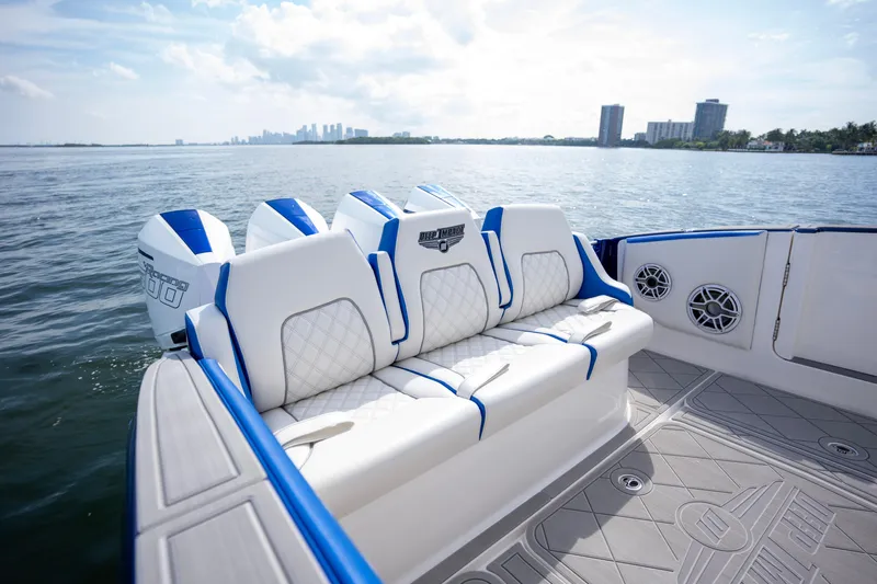  Yacht Photos Pics 2024 Deep Impact 399 Sport boat with luxurious seating on a sunny day.