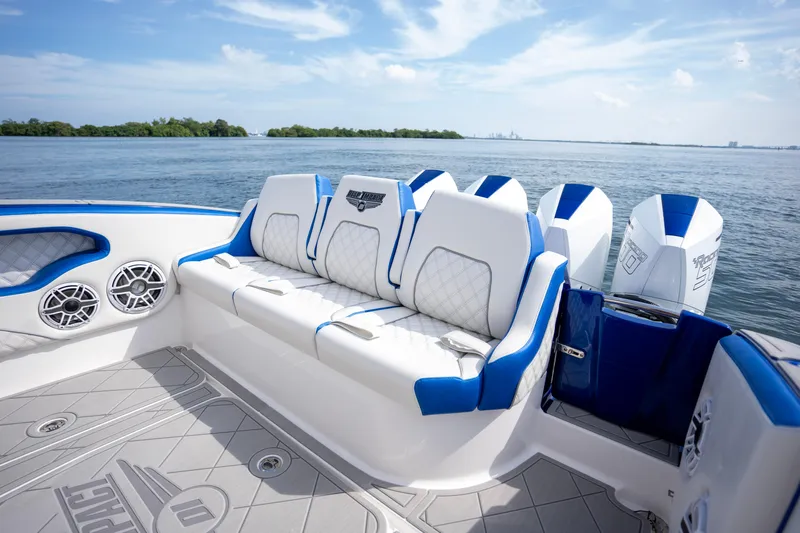  Yacht Photos Pics 2024 Deep Impact 399 Sport boat interior with luxurious seating and powerful engines on a sunny day.