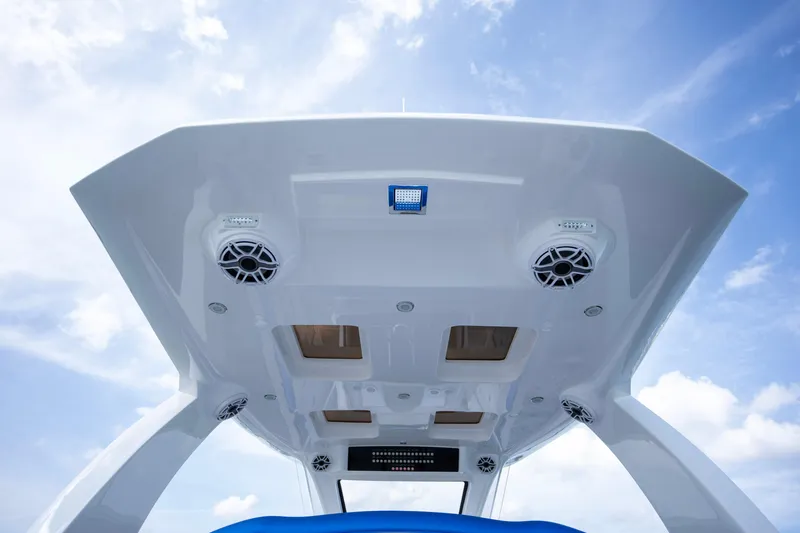  Yacht Photos Pics 2024 Deep Impact 399 Sport boat roof with speakers and sky background.