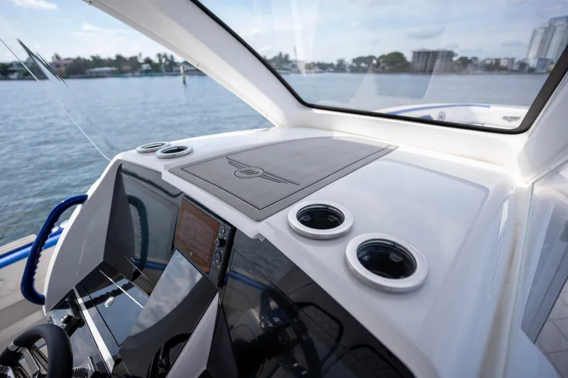  Yacht Photos Pics 2024 Deep Impact 399 Sport boat dashboard with modern controls and scenic water view.