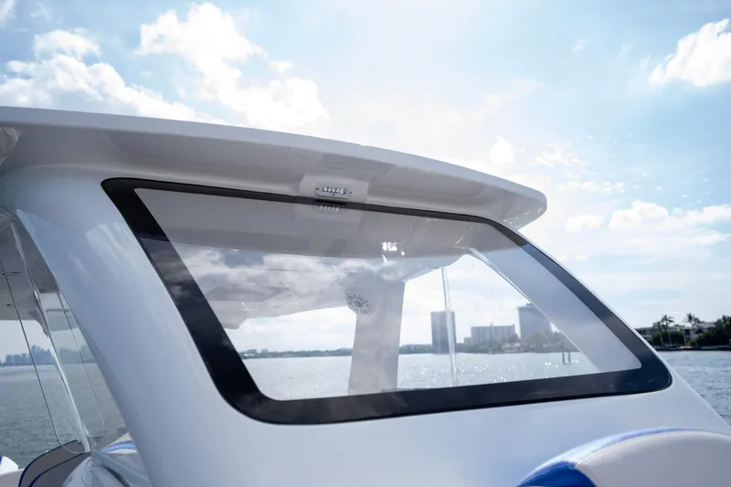  Yacht Photos Pics 2024 Deep Impact 399 Sport boat with sleek design and modern window, under a clear sky.