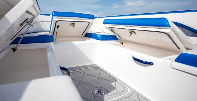  Yacht Photos Pics 2024 Deep Impact 399 Sport boat interior with blue and white seating and storage compartments.