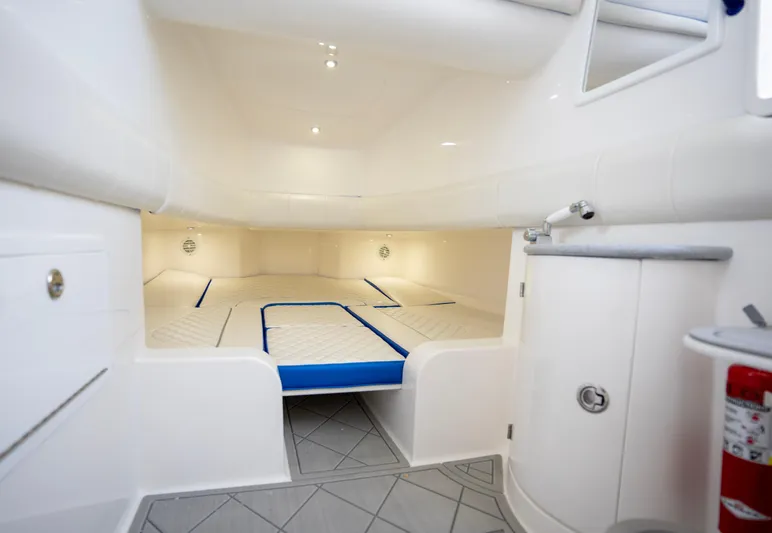  Yacht Photos Pics 2024 Deep Impact 399 Sport cabin interior with white and blue accents.