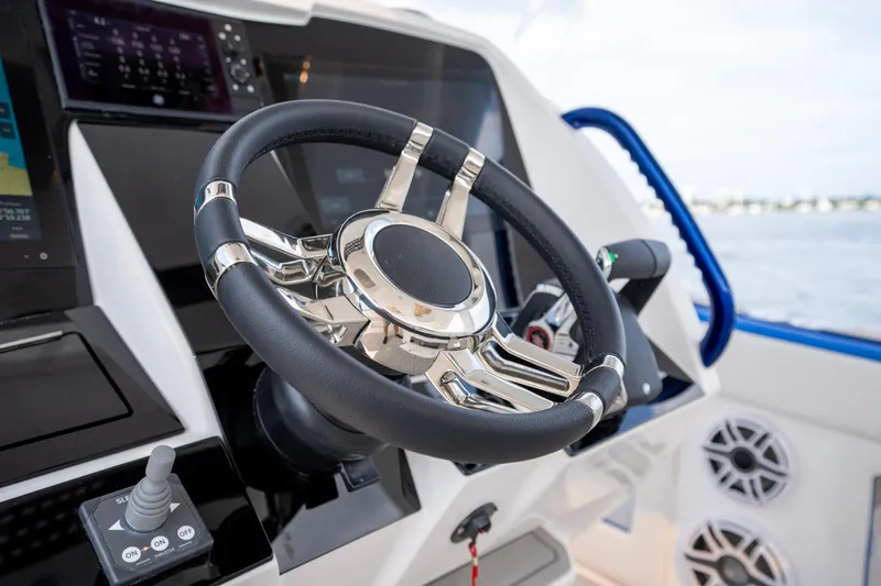  Yacht Photos Pics Steering wheel of 2024 Deep Impact 399 Sport boat, featuring modern controls and sleek design.