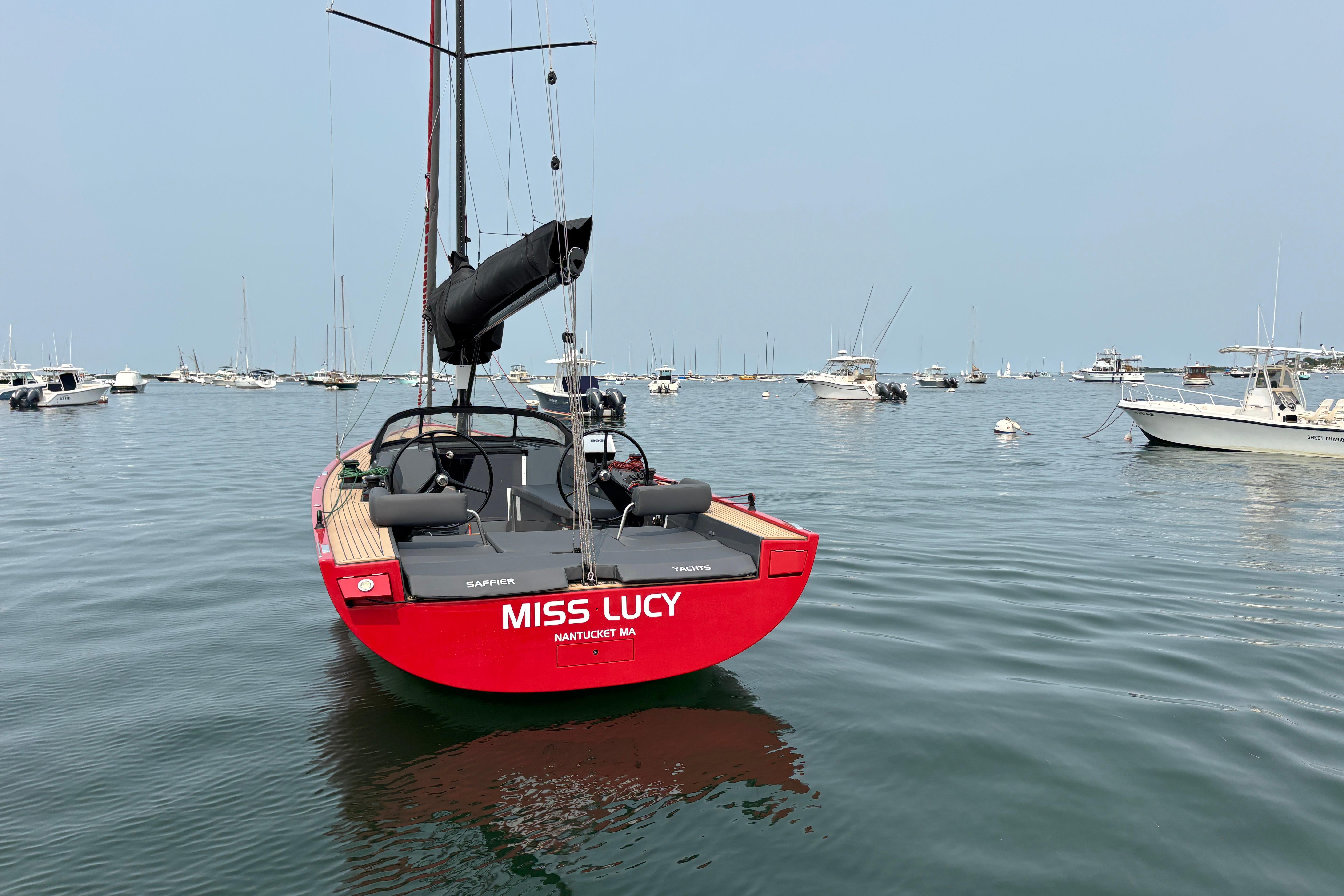 Red 2023 Saffier 33 Life sailboat named "Miss Lucy" in a calm harbor.