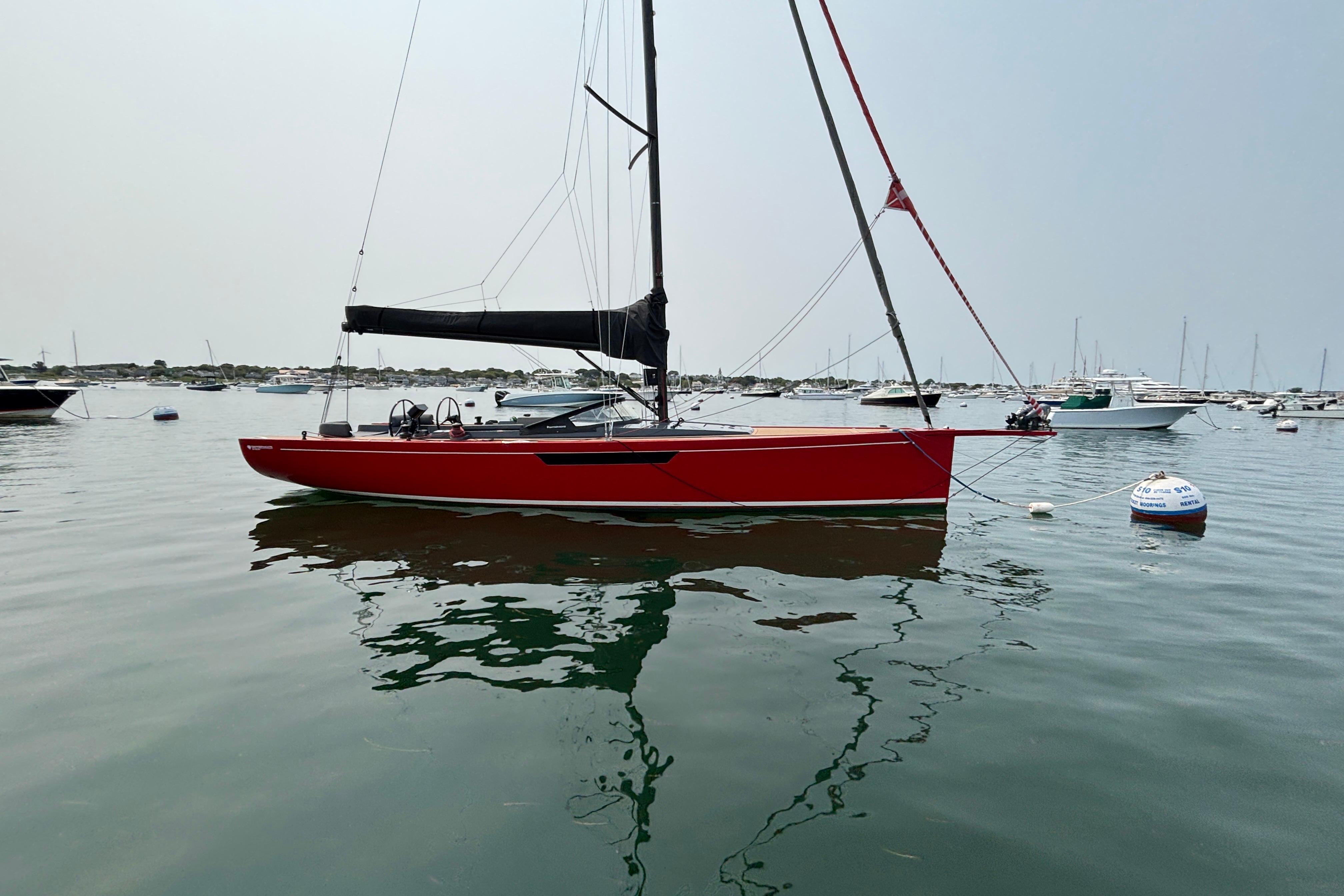 2023 Saffier 33 Life sailboat in calm waters, featuring a sleek red hull design.