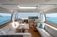 Luxurious interior of 2026 Solaris Power 60 yacht with ocean view and elegant seating.