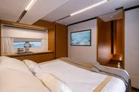 Luxurious interior of 2026 Solaris Power 60 yacht bedroom with modern design and elegant decor.